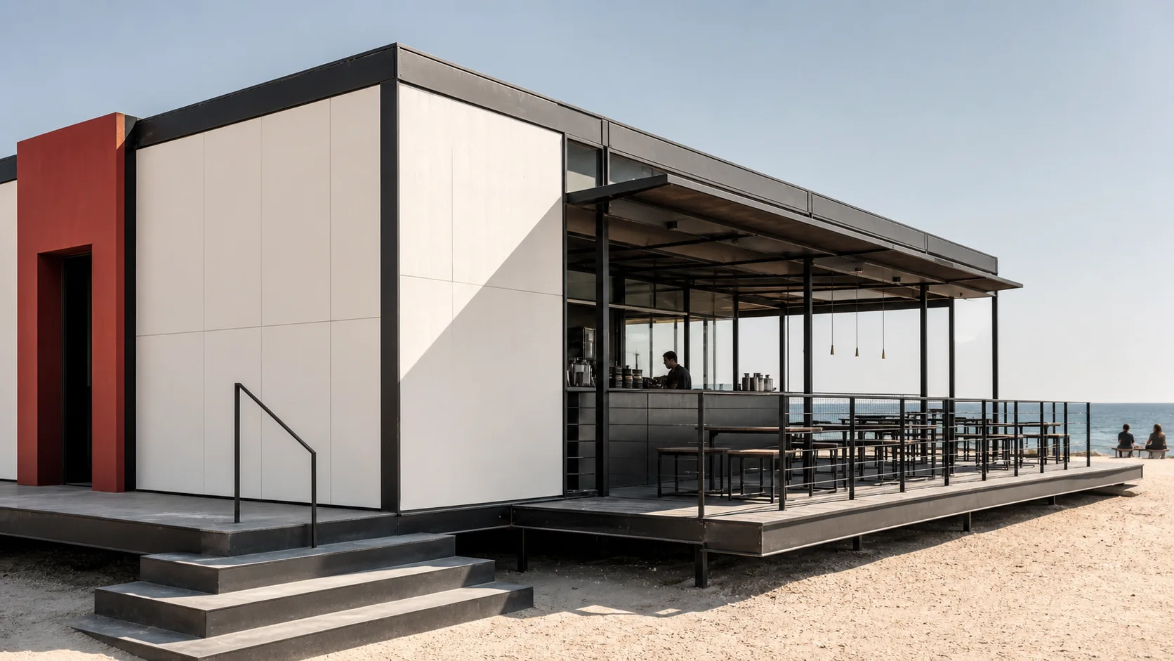 Off-white and charcoal modular beachside café with a red entrance